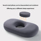 Dark gray memory foam pillow with its round center pad lifted out to show the hollow