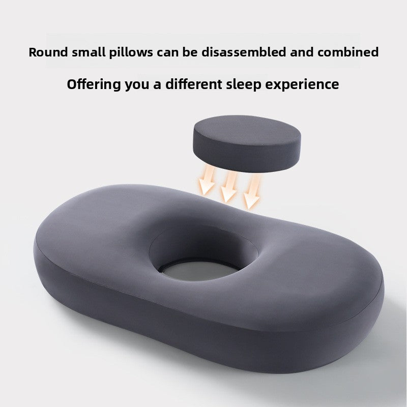 Dark gray memory foam pillow with its round center pad lifted out to show the hollow