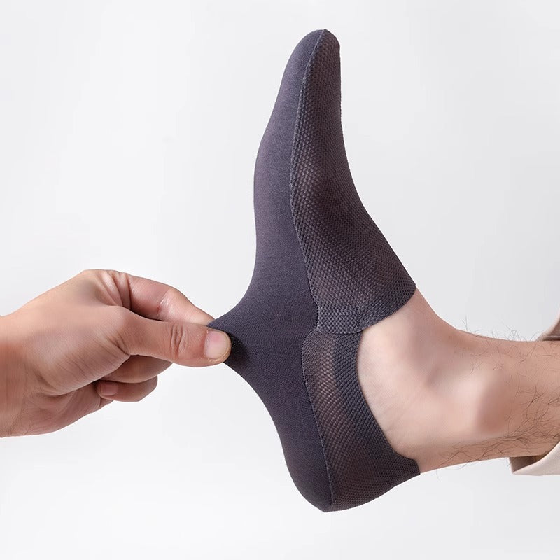 Dark gray no-show sock held in hand showing the deep low-cut elastic front opening