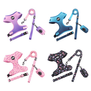 Four colourways of the dog harness and leash set laid out, purple, blue, floral black and pink