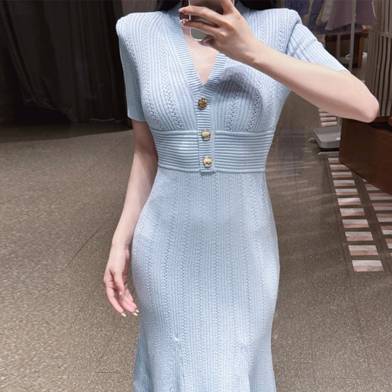 Elegant V-neck knitted dress, side profile showing the fitted waist