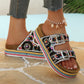 Open toe sandal worn on cobblestone street