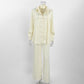 Woman in the buttercream self tie shirt and wide leg trousers matching set, relaxed standing pose