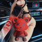 Gloomy bear keychain shown from the front with drawn on X eyes and starry speckles
