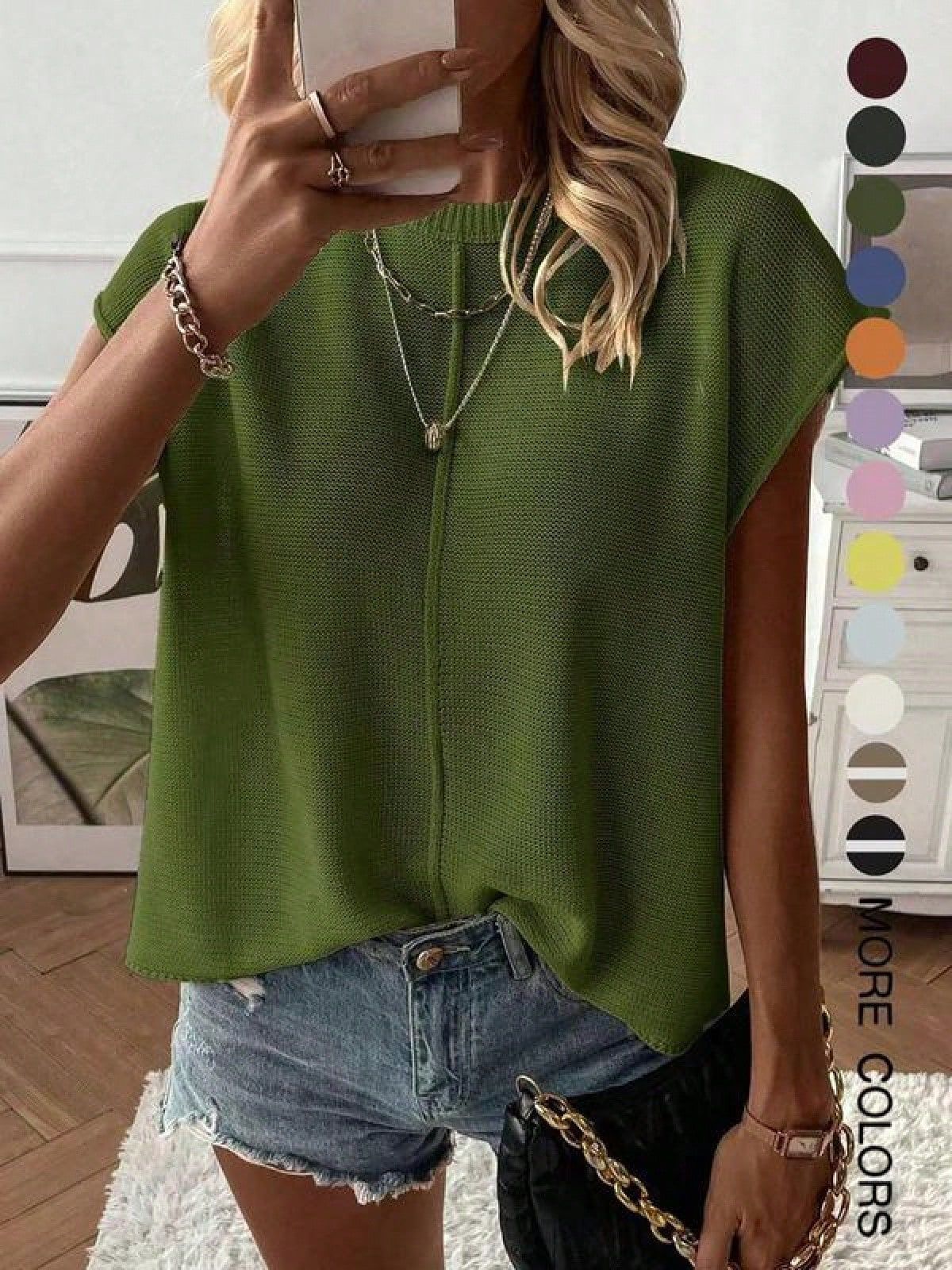 Relaxed fine knit top with a round neck and cap sleeves styled with denim shorts