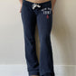 Navy low-rise flared drawstring sweatpants with New York 1987 print worn side back view