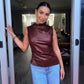 Back view of the sleeveless faux leather mock neck top and clean armholes