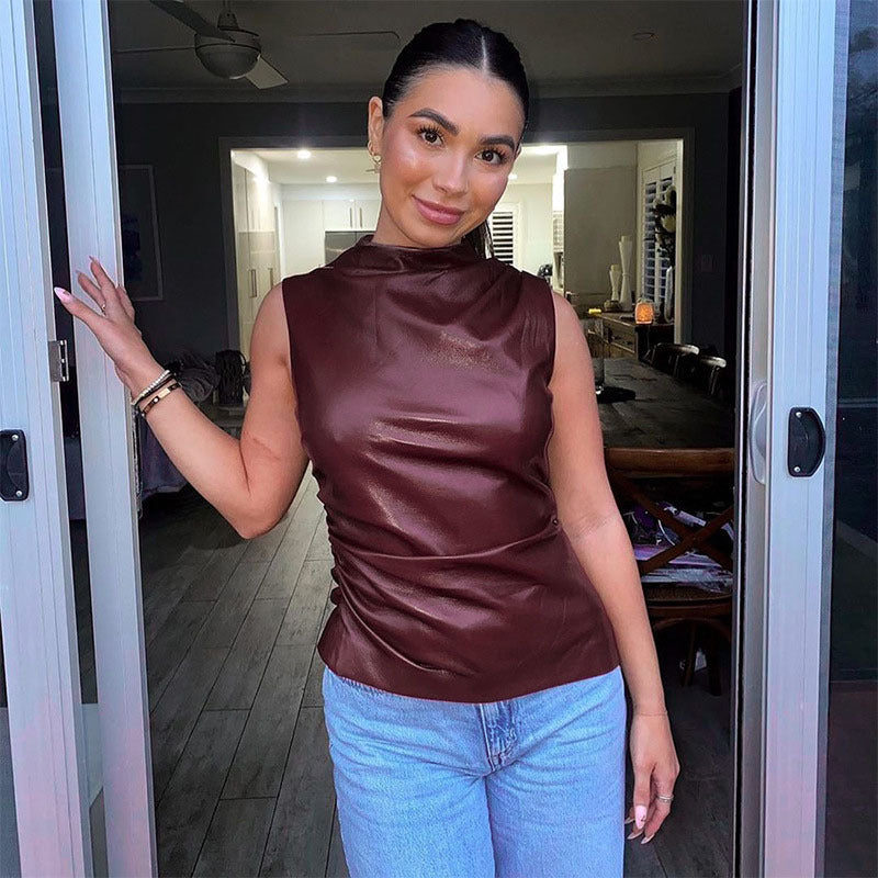 Back view of the sleeveless faux leather mock neck top and clean armholes