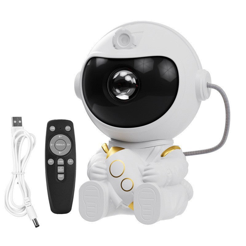 White astronaut shaped star projector with a tinted visor lens and gold trim