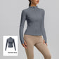 Woman in a slate grey slim fit stand collar zip jacket with thumb holes, grey swatch inset at the corner