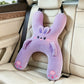 Black and white panda car nap pillow with paw pads on a car seat