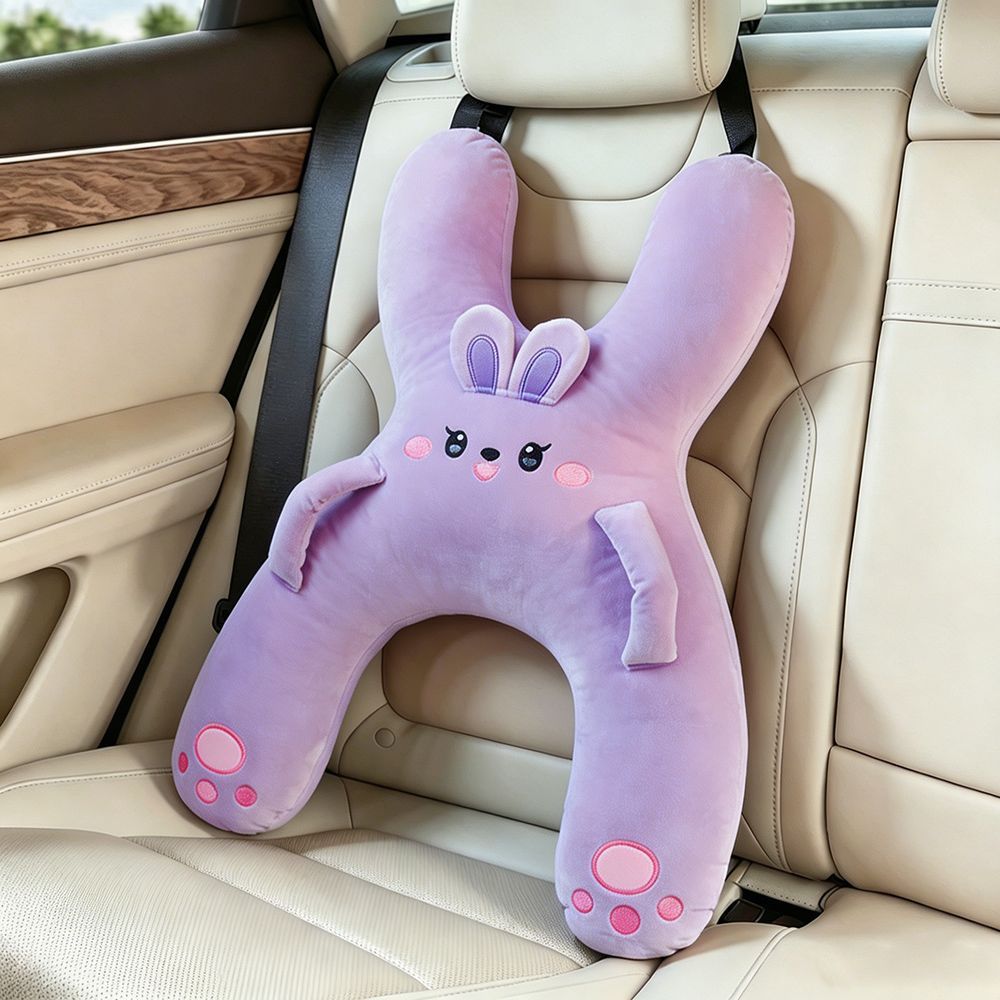 Black and white panda car nap pillow with paw pads on a car seat