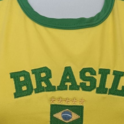 Yellow Brasil baby tee chest detail with green embroidered lettering and flag