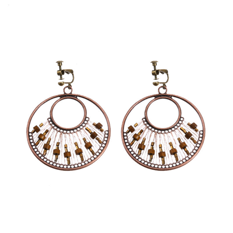 Bohemian tassel and bead clip-on drop earrings, aged tone zinc alloy frame, handmade pair on plain white background