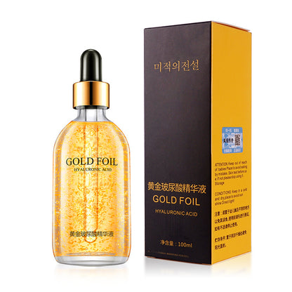 Gold foil hyaluronic acid facial essence dropper bottle beside its printed carton
