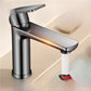 Gunmetal gray single lever basin faucet with a glowing orange line along the spout and a stream of water in a bathroom