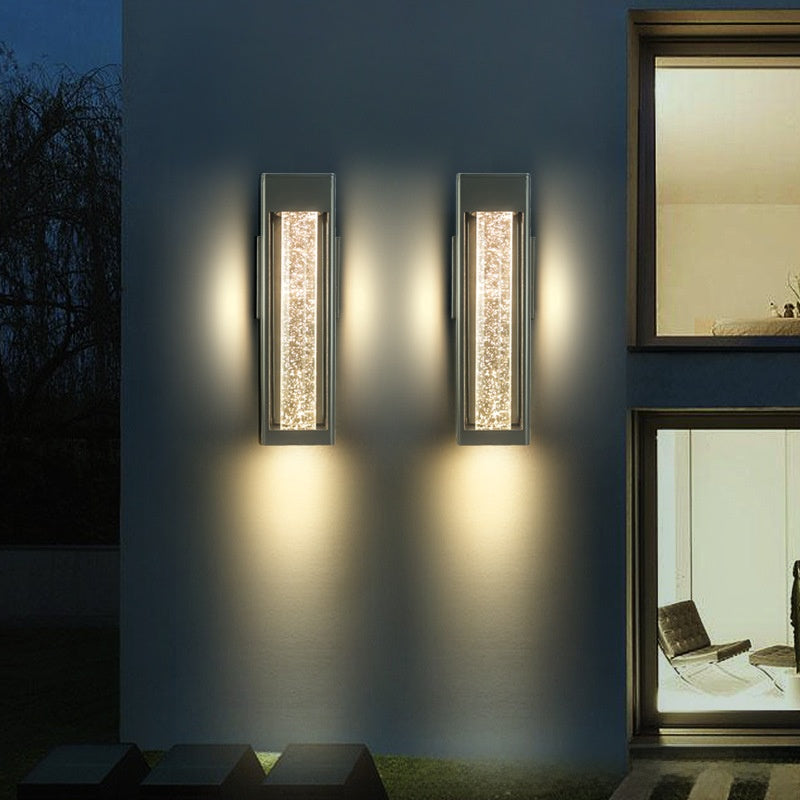 Lit acrylic crystal rod of the wall sconce sparkling with warm LED light
