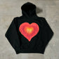 Black pullover hoodie with a No Stylist speaker line printed across the chest