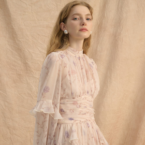Blush floral chiffon dress front showing mock neck and ruched waist sash on model