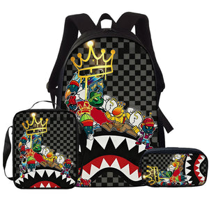 Checker print school backpack with a gold crown, cartoon collage and shark mouth, with matching lunch bag and pencil case