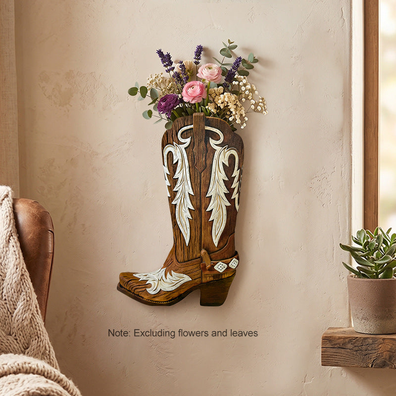 Brown wooden boot wall vase with cream inlay mounted on a plaster wall with dried stems
