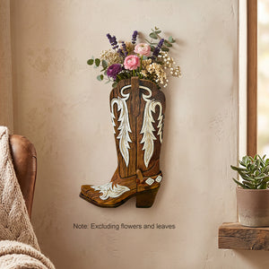 Brown wooden boot wall vase with cream inlay mounted on a plaster wall with dried stems