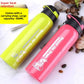Apple green and pink stainless steel sports bottles with black flip lids on wet stones, large capacity 500 ml caption