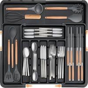 White compartment drawer organizer holding forks spoons and knives in lanes