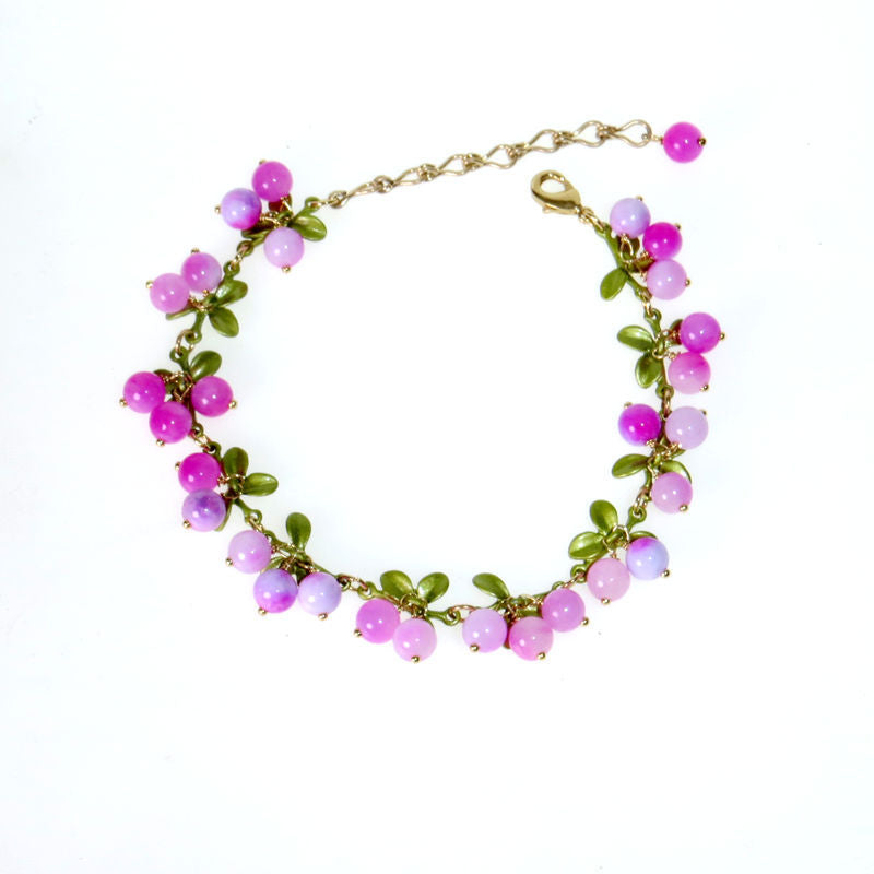 Jade green bead clusters and enamel leaves along a gold tone chain bracelet