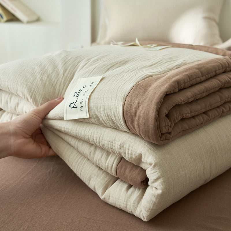 Cream and brown reversible double gauze summer quilt folded with fabric label