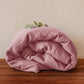 Washed pure linen duvet cover draped over a bed with matching linen pillows