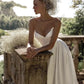 Strapless satin wedding gown with a small sweep train trailing on a path