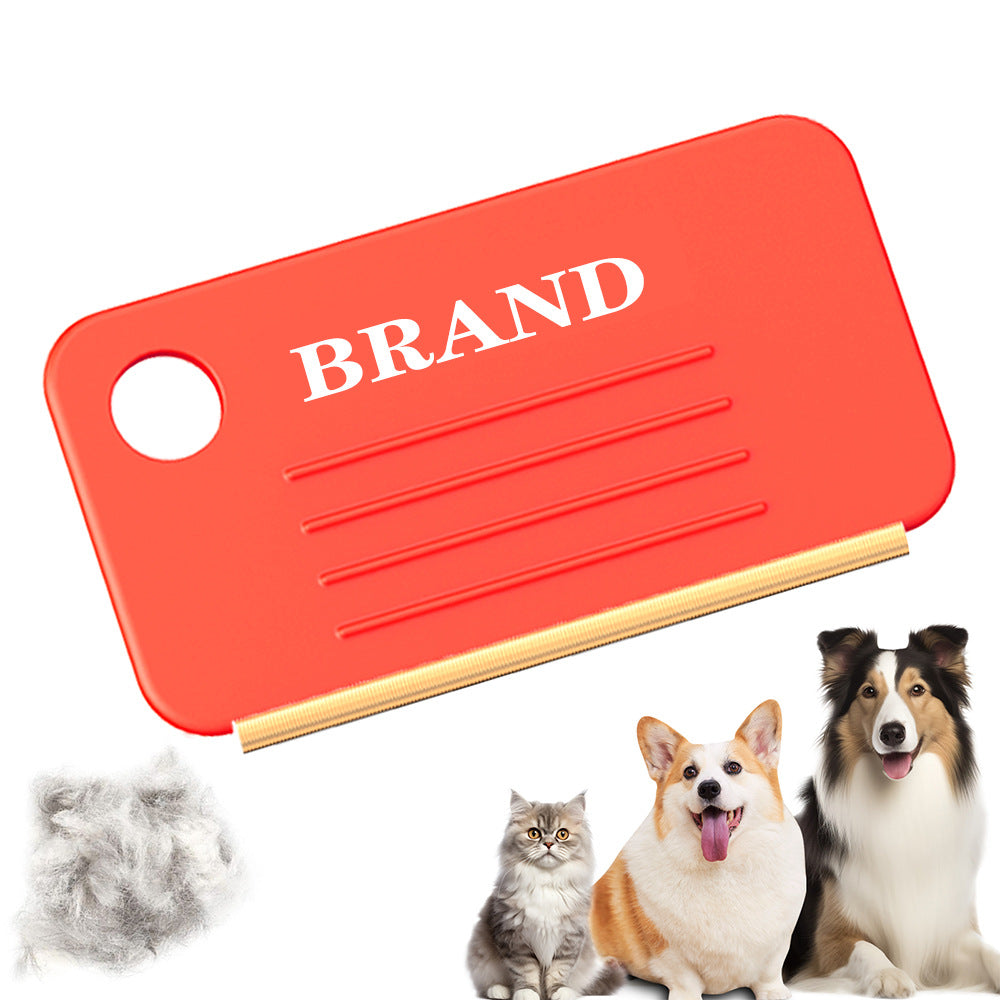 Mini orange pet hair remover brush the size of a card, with a hanging hole and a gold-tone edge