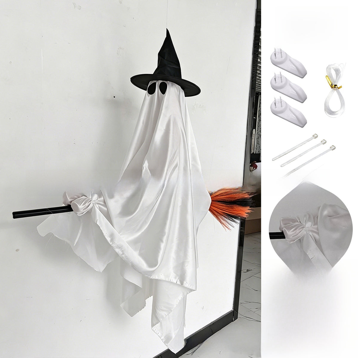 Full length view of the hanging broom ghost showing the cloth body and witch hat