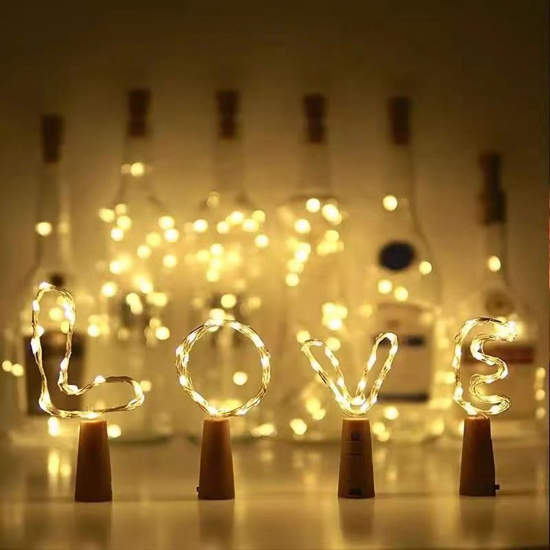 Bottle stopper string lights shaped into letters in warm white
