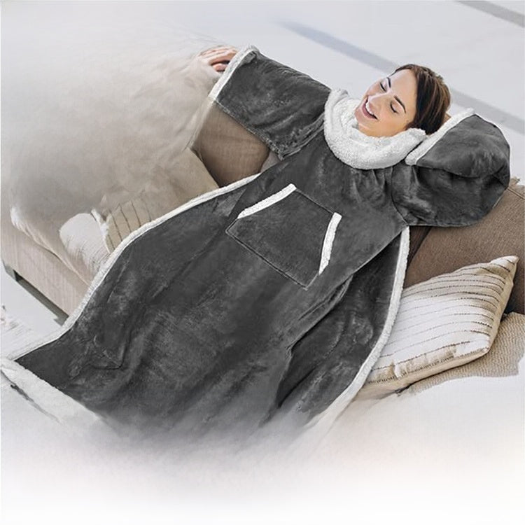 Woman reclining on a sofa in a gray sleeved blanket with sherpa collar, cuffs and pocket trim