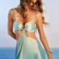 Close-up of the gradient satin fabric and soft sheen on the halter dress