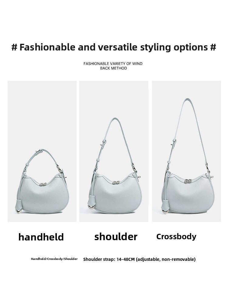 Crescent bag shown carried by hand, on the shoulder and crossbody, strap adjustable from 14 to 48 cm