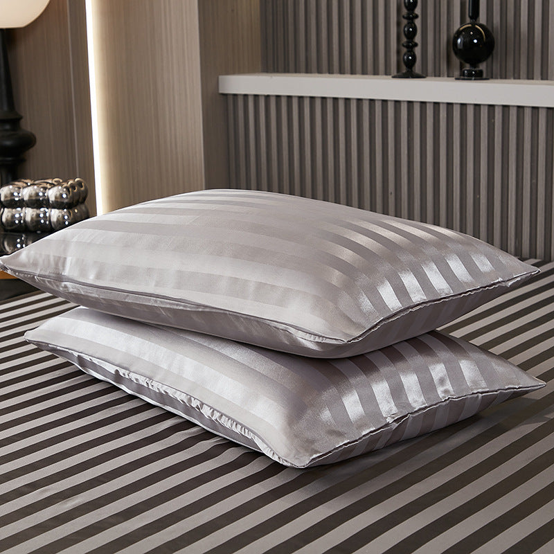Smooth satin pillowcase with a soft sheen shown on a made bed