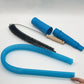 Flat lay of the kit, a flexible bristle brush, a blue flexible hose, and two blue vacuum adapters