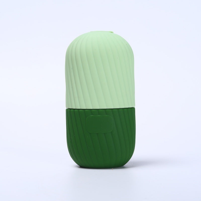 Two tone pink silicone facial ice tool standing, rounded gliding end facing up