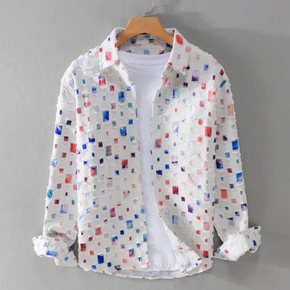 White ground shirt jacket with a grid of frayed multicolor patches on a hanger