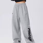 Womens wide leg sweatpants in marl grey falling long over sneakers