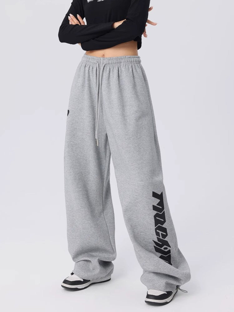 Womens wide leg sweatpants in marl grey falling long over sneakers