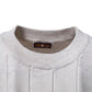 Side view of the cotton knit top showing the short ribbed sleeve and crew neck