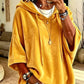 Faintly lustrous hooded top styled over jeans with the hood down