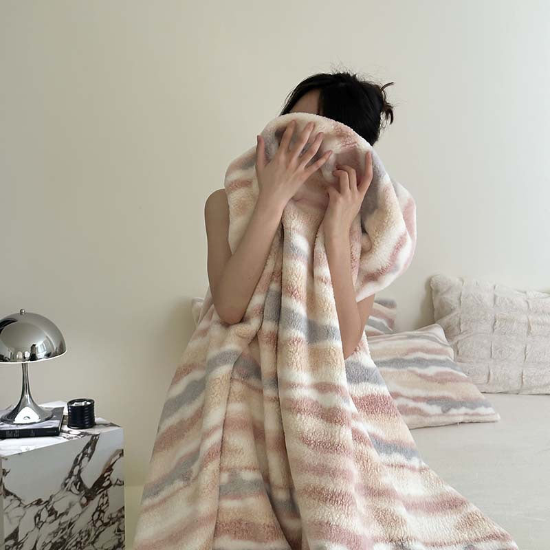 Reference view of the plush pile and printed stripe on the throw blanket