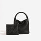 Black woven PU leather bucket bag with rounded plaited handle and zip pouch with wrist loop