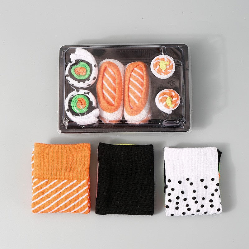 Sushi themed cotton crew socks folded into nigiri and maki shapes on a plate, playful novelty foodie gift