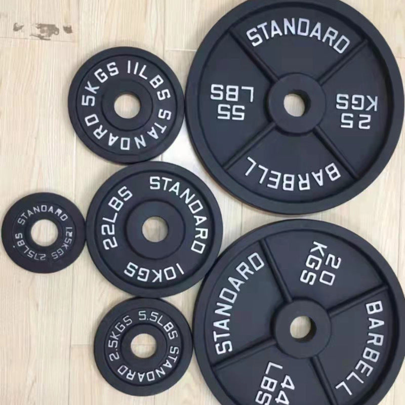 Cast iron barbell plates arranged top down across several kilogram sizes
